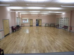 Reverse view of main hall with emtrance doors and Kitchen hatch far end